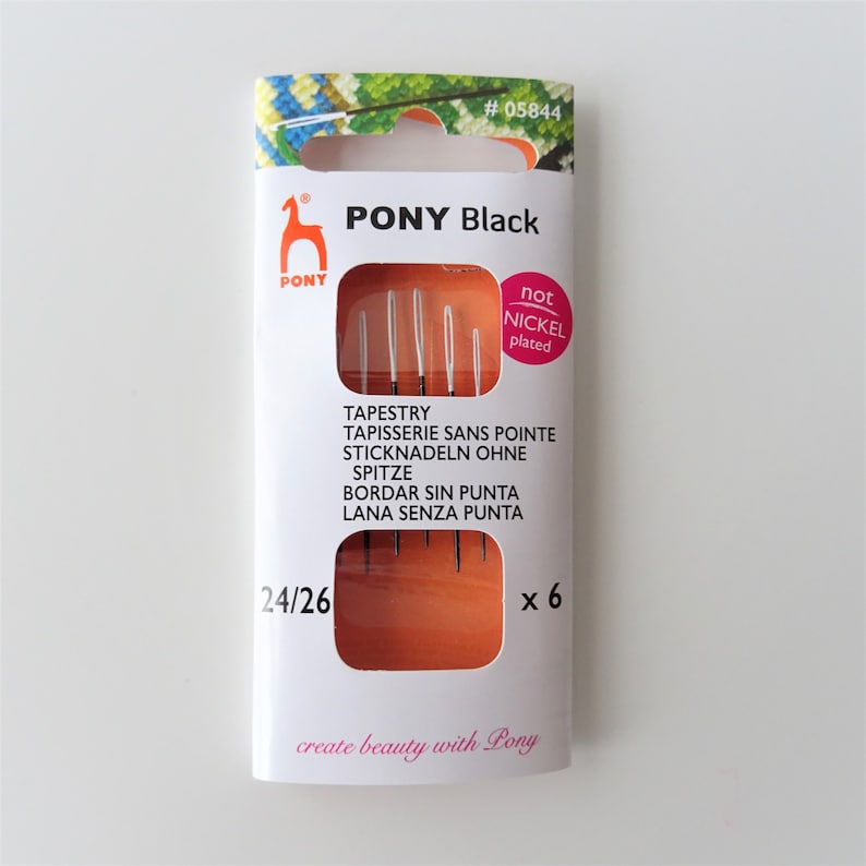 May include: A package of six black tapestry needles, size 24/26, labeled "PONY Black" and "not nickel plated". The package also includes the text "TAPESTRY, TAPISSERIE SANS POINTE, STICKNADELN OHNE SPITZE, BORDAR SIN PUNTA, LANA SENZA PUNTA" and "create beauty with Pony".