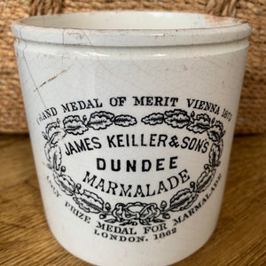 May include: White ceramic jar with black lettering that reads "Grand Medal of Merit Vienna 1873", "James Keiller & Sons", "Dundee", "Marmalade", "Cay Prize Medal for Marmalade London 1862".