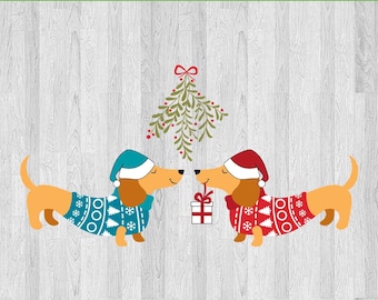 May include: Two dachshund dogs wearing Christmas sweaters and Santa hats are standing under a sprig of mistletoe. The dog on the left is wearing a blue sweater with white snowflakes and the dog on the right is wearing a red sweater with white snowflakes. The dog on the right is holding a small gift box.