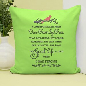 May include: A green throw pillow with a red cardinal on a branch and the text "A limb has fallen from our family tree that says grieve not for me remember the best times the laughter, the song the good life I lived when I was strong".