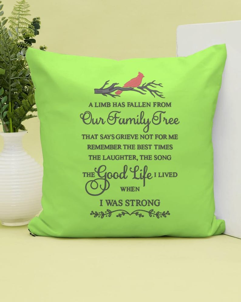 May include: A green throw pillow with a red cardinal on a branch and the text "A limb has fallen from our family tree that says grieve not for me remember the best times the laughter, the song the good life I lived when I was strong".