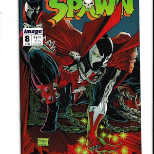 May include: Comic book cover featuring the character Spawn. The artwork depicts Spawn in a dynamic pose, clad in a black and red costume with chains and a flowing cape. The title "Spawn" is prominently displayed in green.