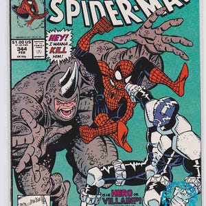 May include: Comic book cover of The Amazing Spider-Man featuring Spider-Man battling Rhino and Cardiac. The cover has a teal background with action-packed illustrations. Text includes "Venom", "Rhino", and "Cardiac".