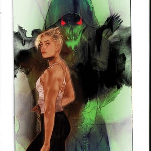 May include: A comic book cover illustration featuring a blonde person in a white tank top and black leggings standing in the foreground. Behind them looms a dark, hooded skeletal figure with glowing red eyes against a vibrant green background.