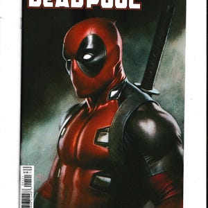 May include: Comic book cover featuring Deadpool, a Marvel Comics character. The cover art shows Deadpool in his signature red and black suit, with a katana on his back. The title "Wade Wilson Deadpool" is prominently displayed.
