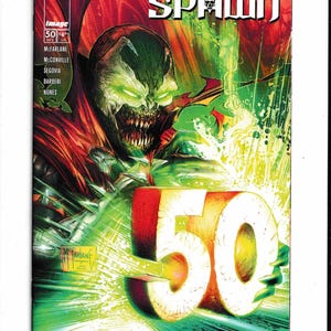 May include: Comic book cover for King Spawn #50. The cover features a menacing character with glowing green eyes and a gaping mouth. The number "50" is prominently displayed in red and white, with the title "King Spawn" at the top.