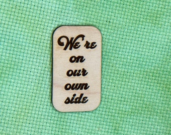 On Our Own Side - Laser engraved wood needleminder or magnet
