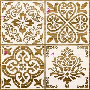 May include: Four different tile stencils with intricate floral designs. The stencils are numbered 1 through 4. The stencils are made of a white material and are set against a brown wooden background.
