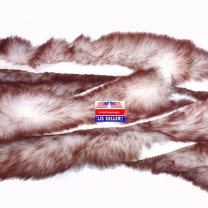 May include: A long, brown and white faux fur scarf. The fur is soft and fluffy, and the scarf is perfect for adding a touch of warmth and style to any outfit.