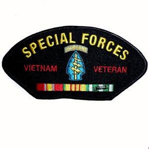 May include: A black embroidered patch with a curved top and bottom edge. It features the yellow text SPECIAL FORCES, a central blue arrowhead emblem with a yellow lightning bolt and AIRBORNE tab, red text VIETNAM VETERAN, and a ribbon bar.