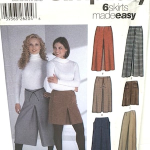May include: Simplicity pattern 5802 for sewing six skirts. The image shows different skirt designs in colours like brown, blue, and plaid. The pattern includes sizes HH 6, 8, 10, 12, and EUR 32-38, FR 34-40.