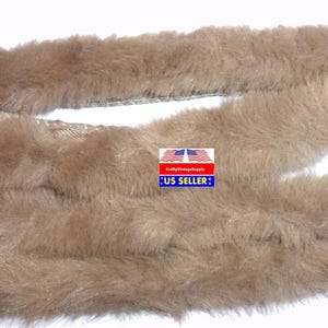 May include: A long, brown faux fur trim. The fur is soft and fluffy, and it is perfect for adding a touch of luxury to any project.