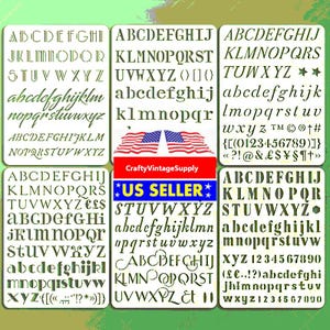 May include: A collection of six white plastic letter and number stencils. Each stencil features a different font style, including uppercase and lowercase letters, numbers, and symbols. The stencils are ideal for various craft projects.