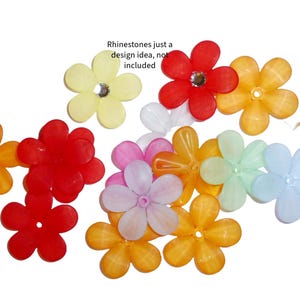 May include: Assortment of colorful plastic flower-shaped beads. The beads are translucent and have a shiny finish. The beads are in various colors, including red, orange, yellow, green, blue, and purple.