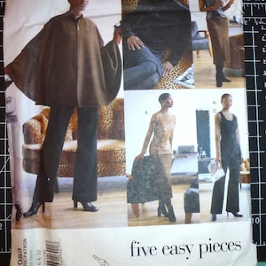 May include: A sewing pattern titled "five easy pieces" featuring images of a woman modeling various outfits. The outfits include a brown cape, black pants, a long-sleeved leopard print top, and a black jumpsuit. The pattern number is 2053.