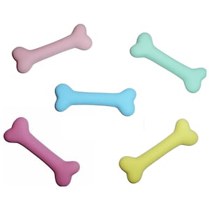 May include: Five colorful plastic dog bone toys. The bones are pink, light blue, light green, yellow, and a darker pink.
