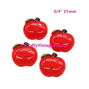 May include: Four red plastic apple shaped buttons with green leaves. The buttons are 3/4 inch or 21 mm in size.