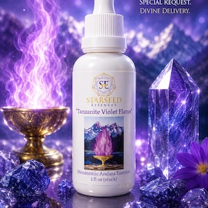 May include: A white dropper bottle labeled Starseed Essences Tanzanite Violet Flame Monatomic Andara Essence 1 fl oz. The label features a mountain landscape with a purple flame. The bottle is surrounded by blue crystals and a purple flower.
