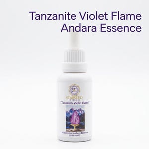 May include: A white dropper bottle labeled Tanzanite Violet Flame Andara Essence. The label features a gold geometric logo, the text Starseed Essences, and an illustration of a purple flame in a golden chalice. It contains 1 fl oz of liquid.
