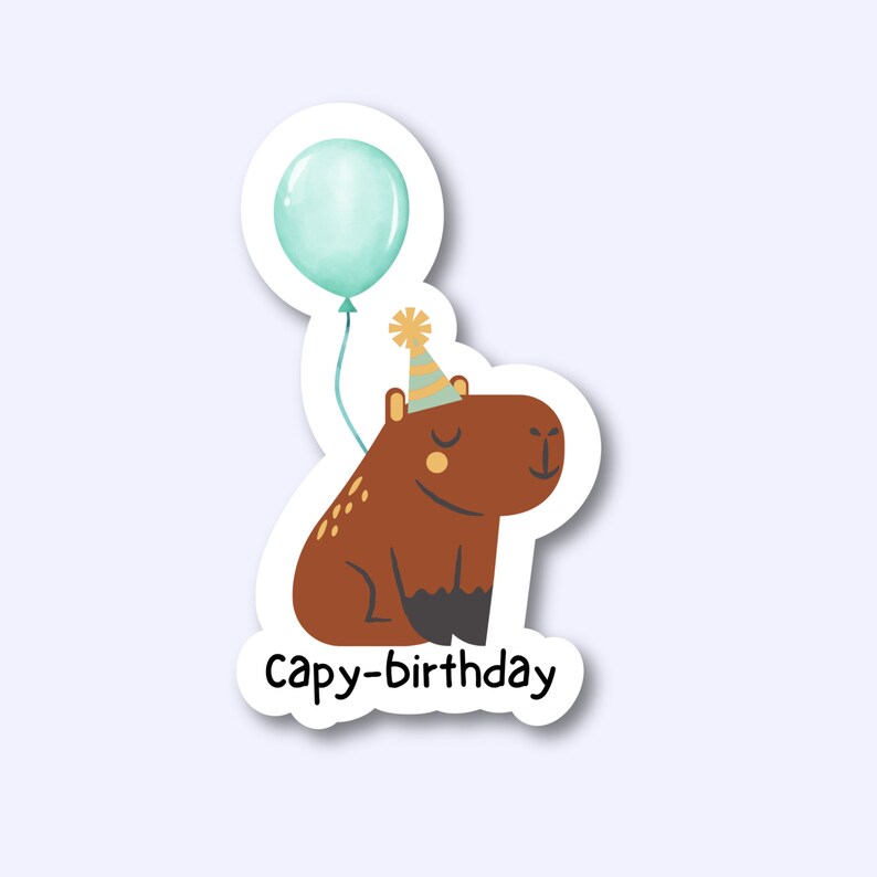 May include: A brown capybara wearing a party hat and holding a blue balloon. The text "capy-birthday" is below the capybara.