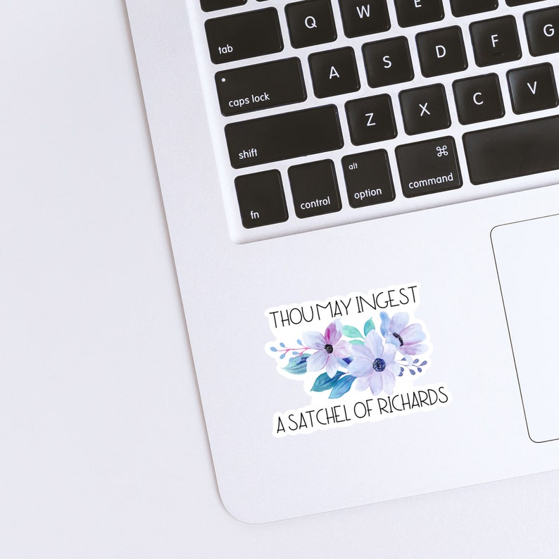 May include: A white laptop with a sticker that says "Thou may ingest a satchel of Richards" with a watercolor floral design in shades of blue, purple, and pink.