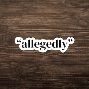 May include: A white sticker with black text that reads "allegedly" on a brown wooden background.