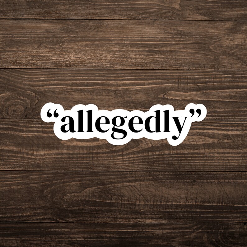 May include: A white sticker with black text that reads "allegedly" on a brown wooden background.