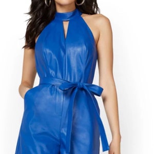 May include: A royal blue faux leather halter jumpsuit with a keyhole neckline and a self-tie belt.
