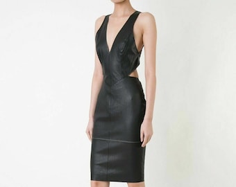 May include: A black leather dress with a plunging neckline and cutouts at the sides. The dress has a fitted silhouette and a midi length.