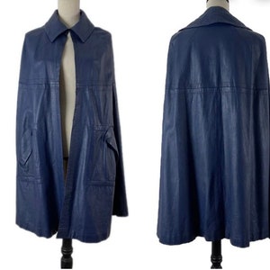 May include: A blue leather cape with a collar and a single button closure. The cape has a pocket on each side and is lined with a smooth fabric.