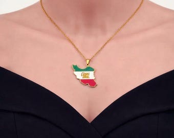 May include: Gold-toned necklace featuring a pendant shaped like the map of Iran. The pendant is colored with the Iranian flag's green, white, and red, and includes the emblem. The necklace is worn against a black top.