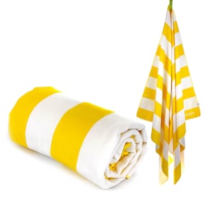 May include: A rolled-up beach towel and a hanging beach towel. Both towels have alternating yellow and white horizontal stripes. The hanging towel is suspended from a green loop. The rolled towel is on a white background.