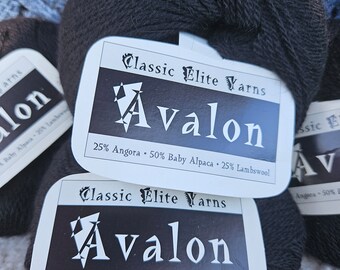 May include: Two skeins of black yarn labeled "Classic Elite Yarns Avalon 25% Angora 50% Baby Alpaca 25% Lambswool"