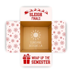 May include: An open cardboard box with a festive design. The box features red snowflakes and the phrases "SLEIGH FINALS" and "WRAP UP THE SEMESTER" in red text. The inside of the box has a sun logo and the text "SUNSHINE DESIGNS LA".