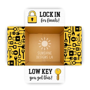May include: An open cardboard box with a yellow and black key pattern on the sides. The top banner reads "LOCK IN for finals!" and the bottom banner says "LOW KEY you got this!" The box interior has a sun graphic.