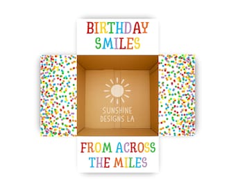 May include: An open cardboard box with colorful confetti on the sides. The top of the box reads "BIRTHDAY SMILES" in rainbow colors. The bottom of the box reads "FROM ACROSS THE MILES" in rainbow colors.