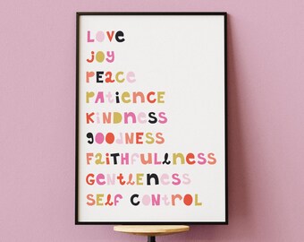 May include: A framed print with the words "Love, Joy, Peace, Patience, Kindness, Goodness, Faithfulness, Gentleness, Self Control" in colorful text. The print is displayed on a wooden and metal stool against a pink wall.