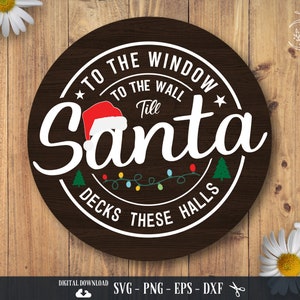 May include: A round, dark brown wooden sign with white text that reads "To the window, to the wall, till Santa decks these halls." A Santa hat, Christmas lights, and two green Christmas trees are also featured in the design. The sign is a digital download.
