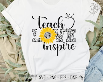 May include: White t-shirt with black text that reads "Teach Love Inspire" with a sunflower and apple graphic. The text is in a leopard print pattern.
