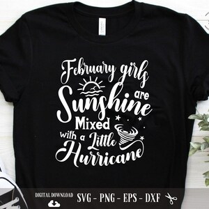 May include: Black t-shirt with white text that reads "February girls are sunshine mixed with a little hurricane". The text is in a cursive font and includes a sun and a tornado graphic.