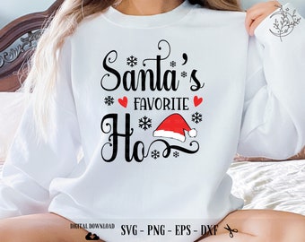 May include: White sweatshirt with black text that reads "Santa's Favourite Ho" with a red Santa hat graphic and snowflakes.