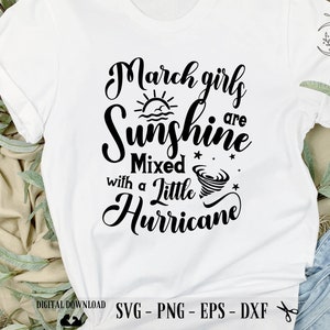 May include: White t-shirt with black text that reads "March girls are sunshine mixed with a little hurricane". The text is in a cursive font and includes a sun and a tornado graphic.