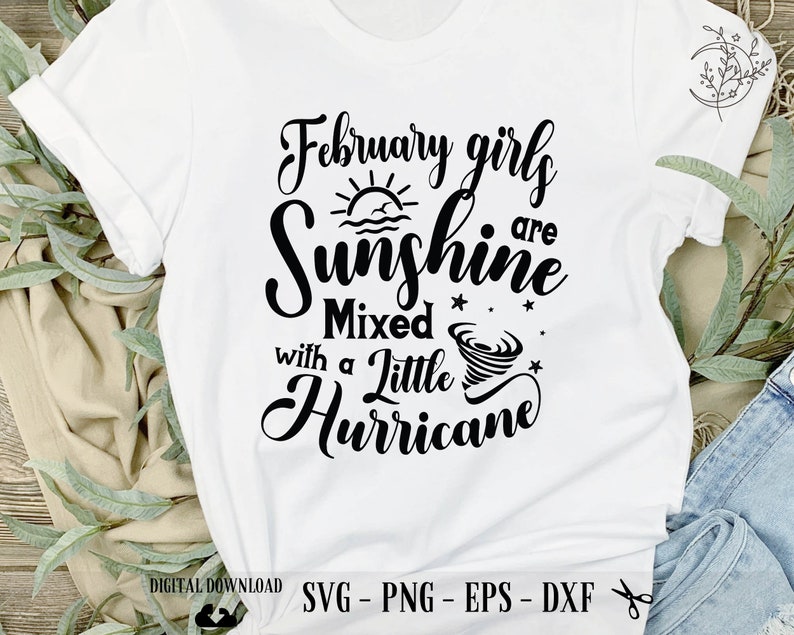May include: White t-shirt with black text that reads "February girls are sunshine mixed with a little hurricane". The text is in a cursive font and includes a sun and a tornado graphic.