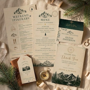 May include: A collection of rustic wedding stationery with a mountain theme. Includes a weekend itinerary, menu, welcome card, thank you card, and a tag. The color palette is neutral with forest green accents.