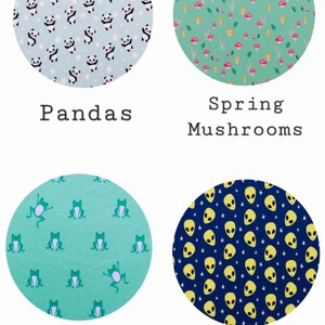 May include: Four different fabric swatches with various patterns. The top left swatch features a light blue background with white stars and black panda bears. The top right swatch features a light green background with white leaves, yellow flowers, and red mushrooms. The bottom left swatch features a light green background with green frogs. The bottom right swatch features a dark blue background with yellow stars and yellow alien faces.