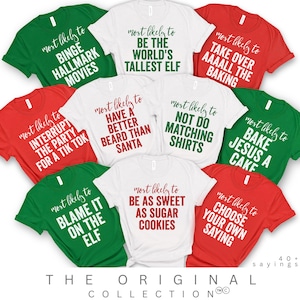Puede incluir: Una colección de camisetas rojas, verdes y blancas, cada una con una frase humorística diferente en negrita. Las frases incluyen "Binge Hallmark Movies", "Be the World's Tallest Elf" y "Choose Your Own Saying". Las camisetas forman parte de "The Original Collection".