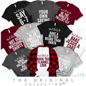 Puede incluir: Una colección de camisetas de varios colores, cada una con una frase humorística en escritura blanca. Las frases incluyen "Say 6-7", "Your Own Saying" y "Rock the Flannel Look". La colección Original se muestra en la parte inferior.
