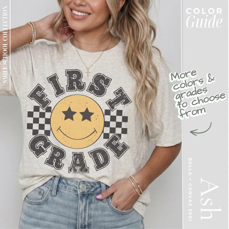 A woman wearing a white t-shirt with a graphic design of a smiling face and the text "FIRST GRADE" printed on it.