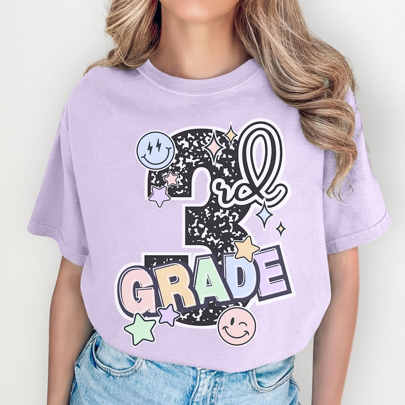 a girl wearing a purple shirt that says 5th grade