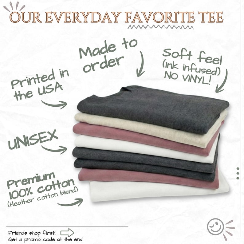 The image is an advertisement for a "Our Everyday Favorite Tee" featuring a stack of various colored shirts, including black, gray, pink, and white. The text highlights the shirt's features, such as being made in the USA, unisex, premium cotton, and no vinyl. The ad also mentions that friends shop first and provides a promotion code at the end.